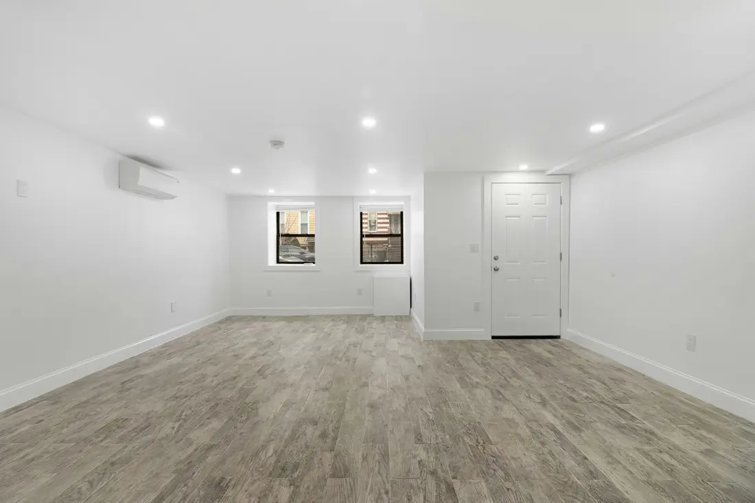 A bright finished basement with high windows