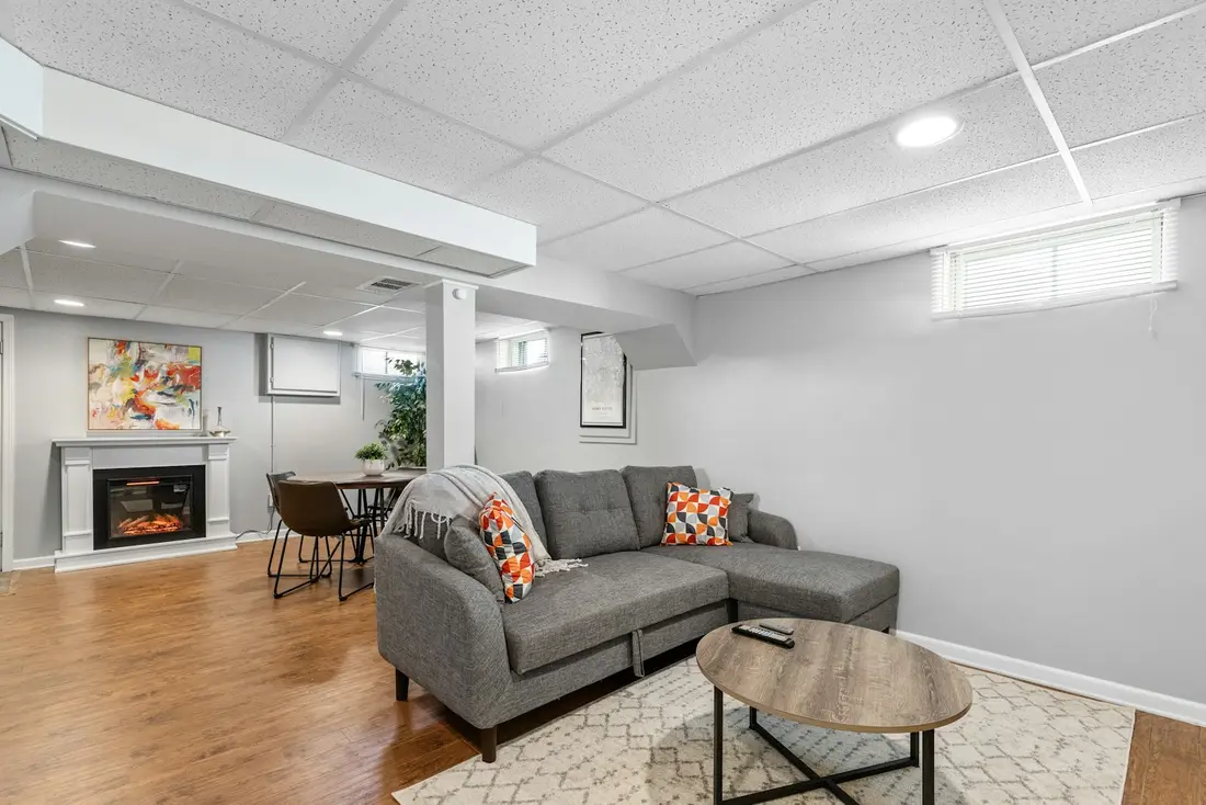 A finished basement living room with daylight from a basement window