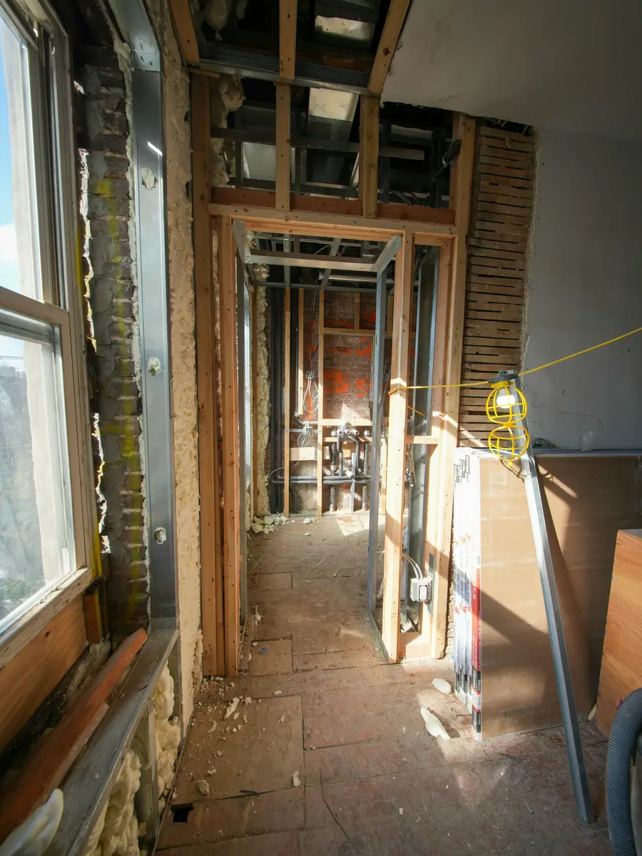 A basement stripped back to brick and new framing during a renovation