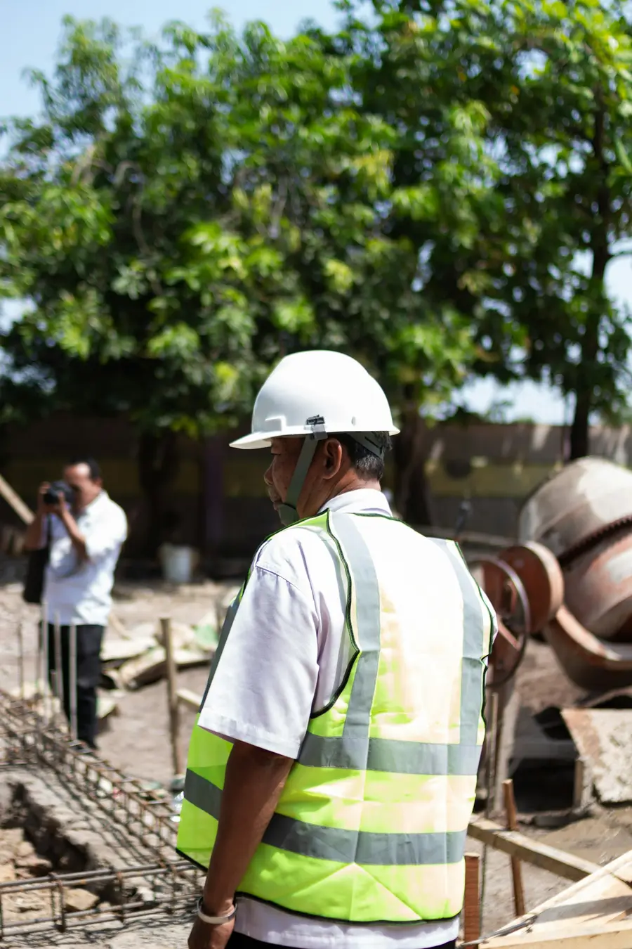 A site worker in a hard hat and high-visibility vest